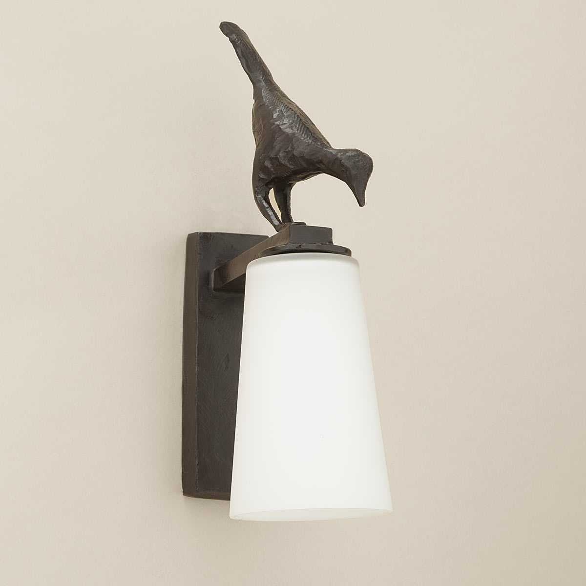 Charming wall light with bird decor made of cast bronze Pia