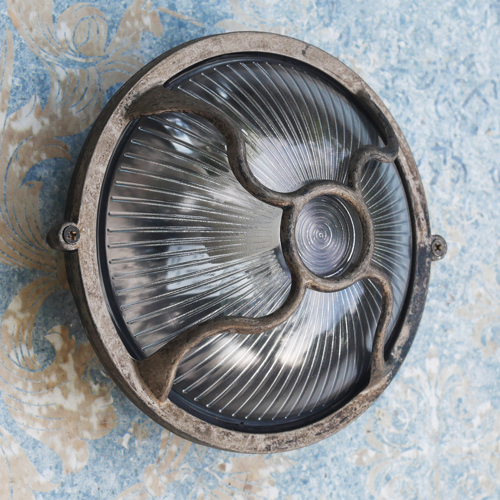 Round cabin brass light with curved grid